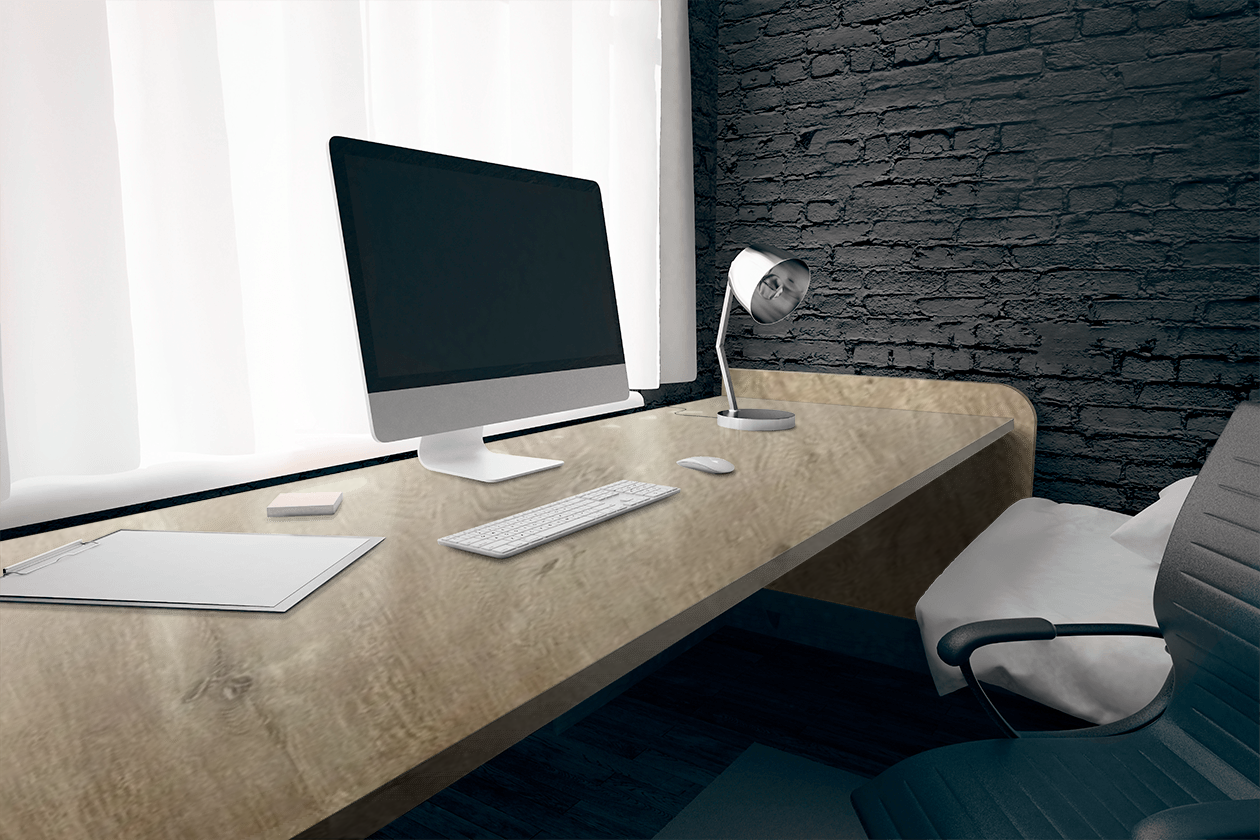 A desk with a computer and a lamp on it.