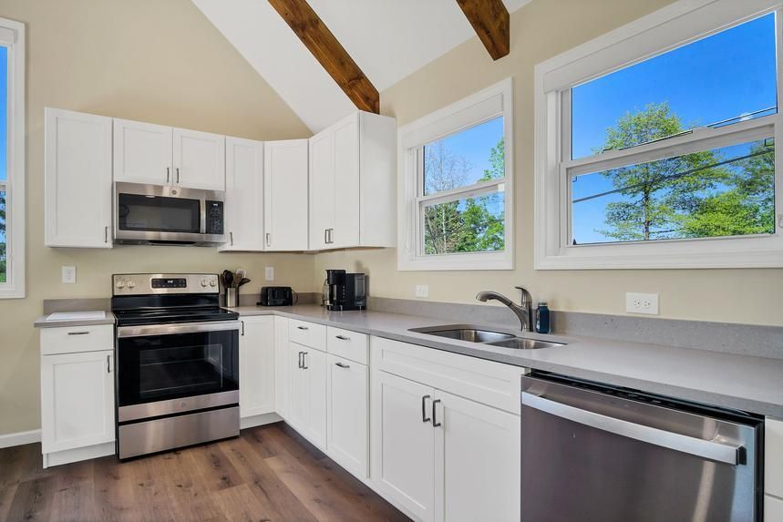 A kitchen with white cabinets and stainless steel appliances.