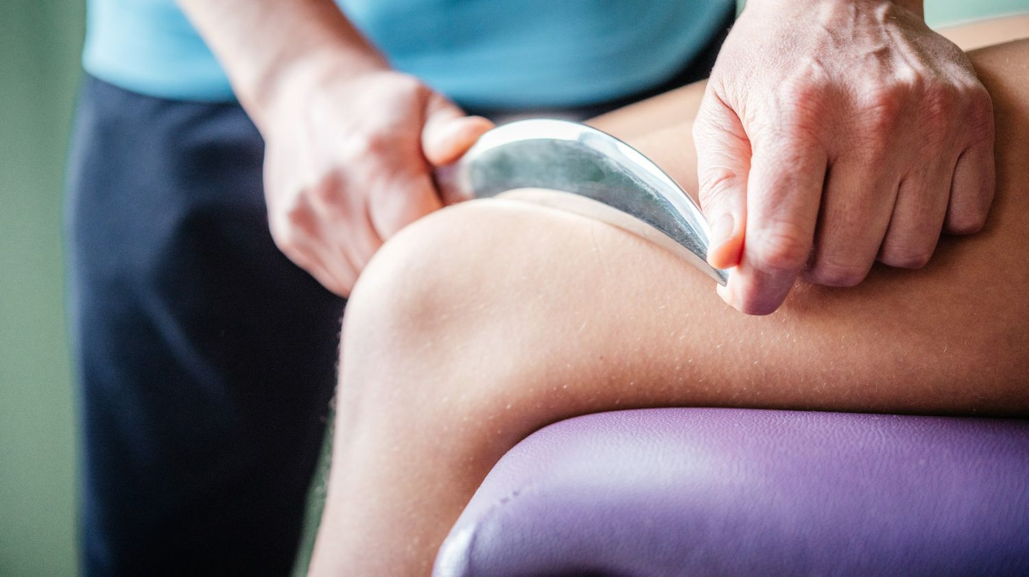 A person is getting a massage on their leg.