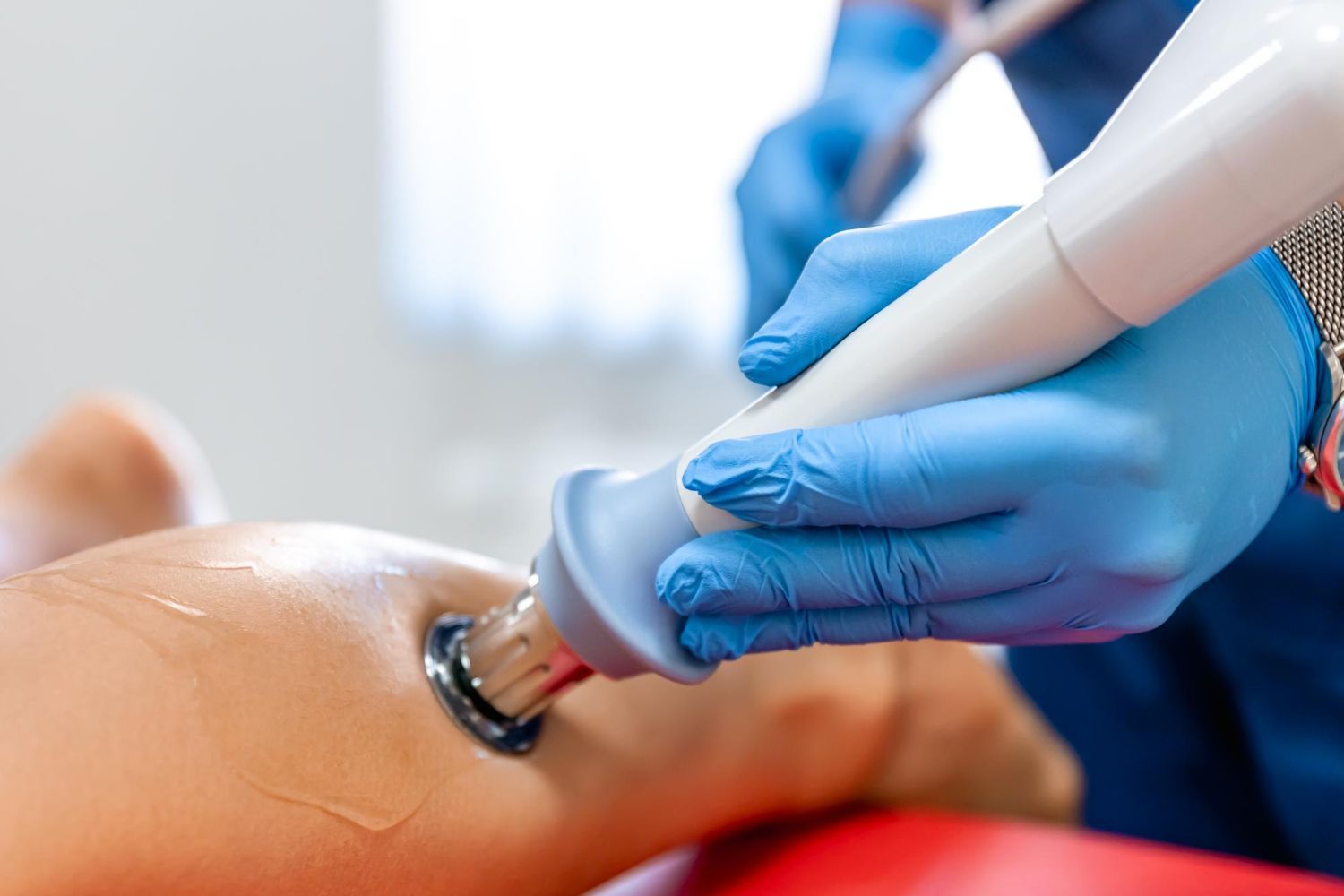 Gloved clinician using a handheld dental scanner on a patient’s mouth