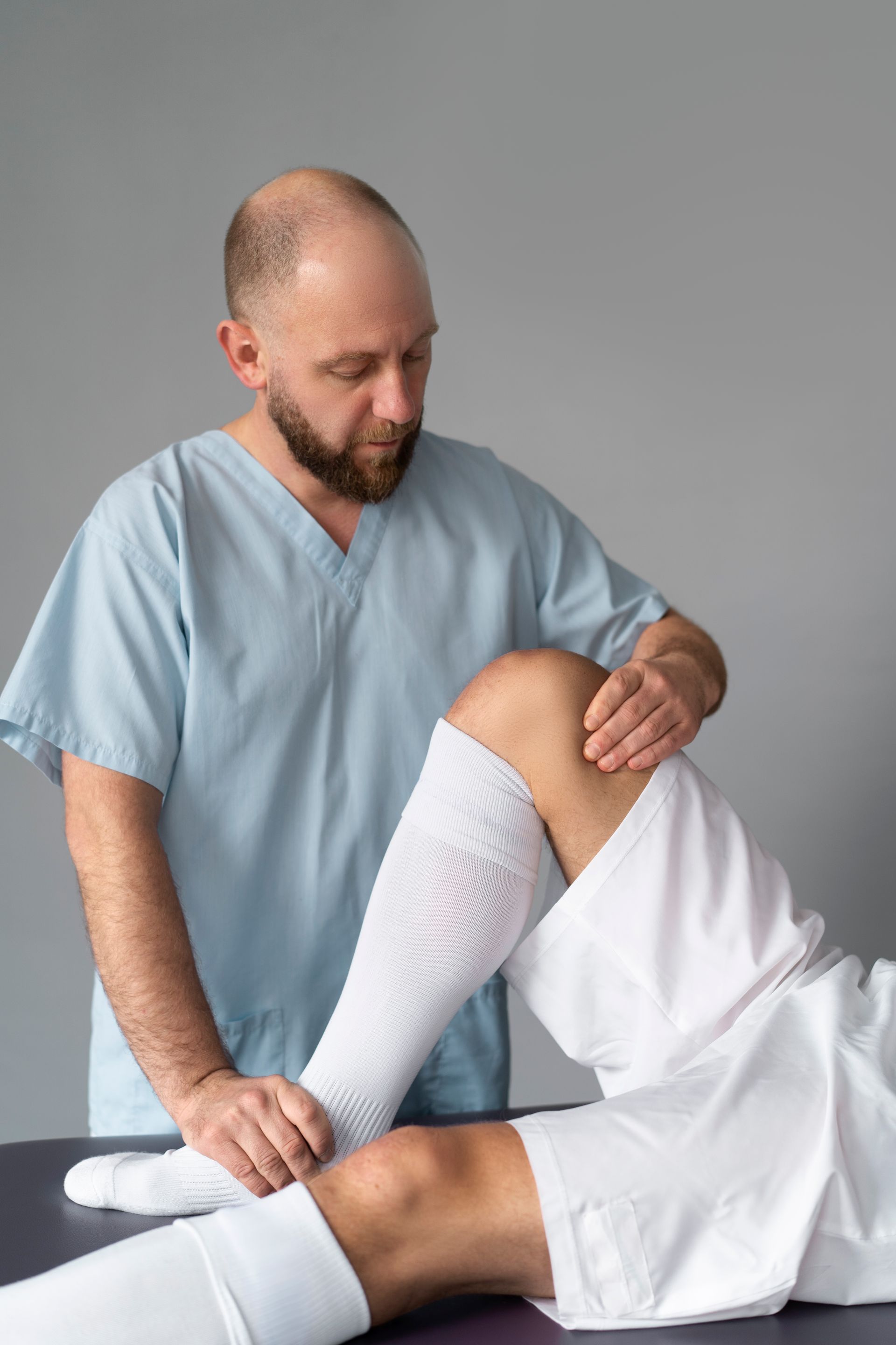 doctor helping patient wearing Compression Stockings