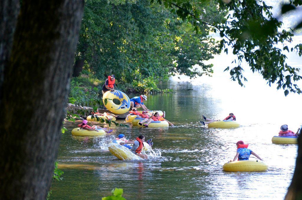 A group of people are tubing down a river