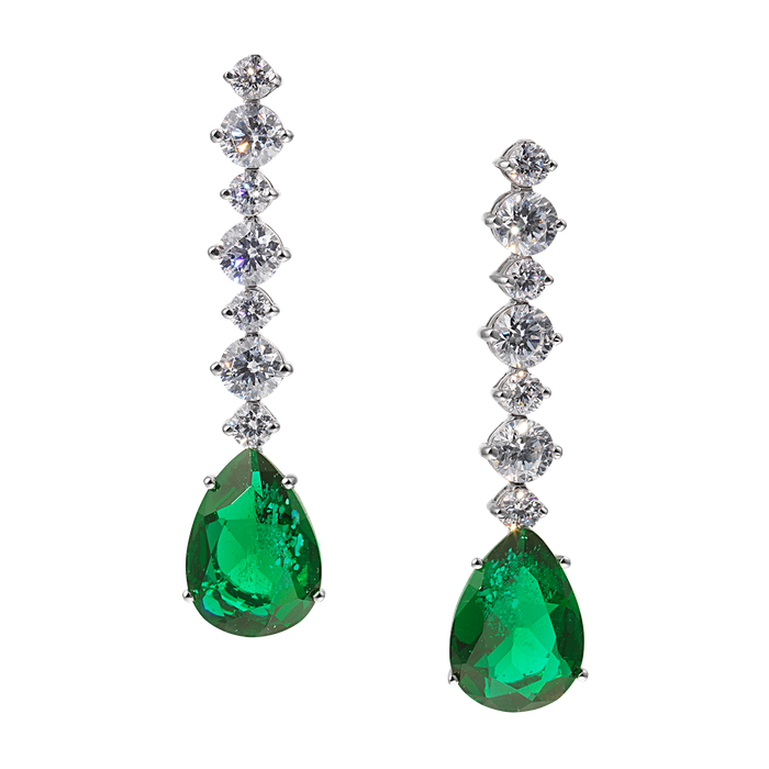 A pair of emerald and diamond earrings on a white background