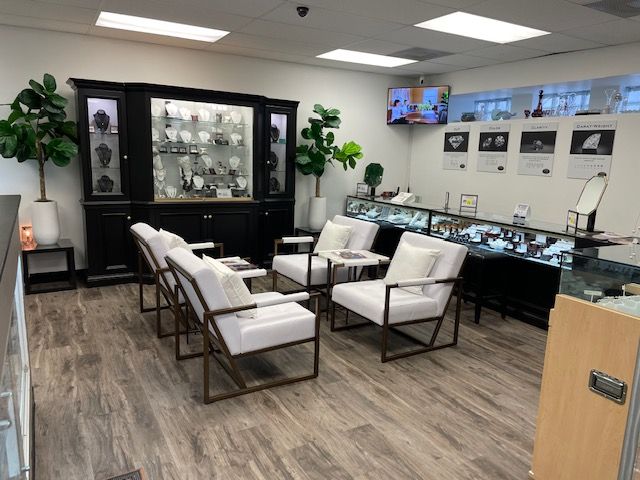 A jewelry store with chairs and a tv on the wall