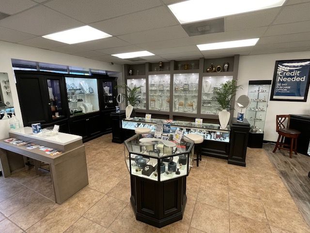 A jewelry store filled with lots of display cases and tables.