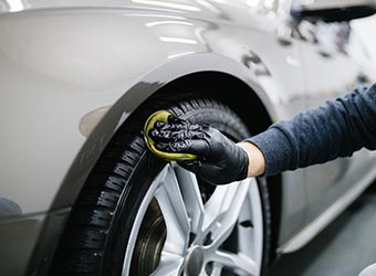 Wiping Tires — Commercial Window Tinting in Leesburg, FL