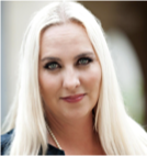 A woman with long blonde hair is smiling for the camera