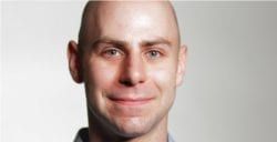 A Bald Man Is Smiling And Looking At The Camera — The Garis Group  In Hamilton, NSW