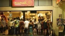 A Group Of People Are Standing Outside Of A Restaurant — The Garis Group  In Hamilton, NSW 