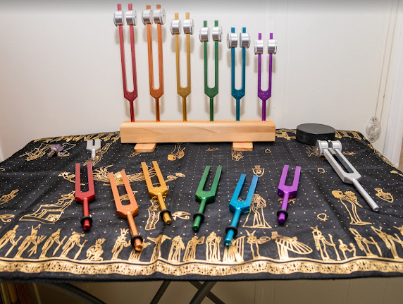 A bunch of colorful forks are on a table