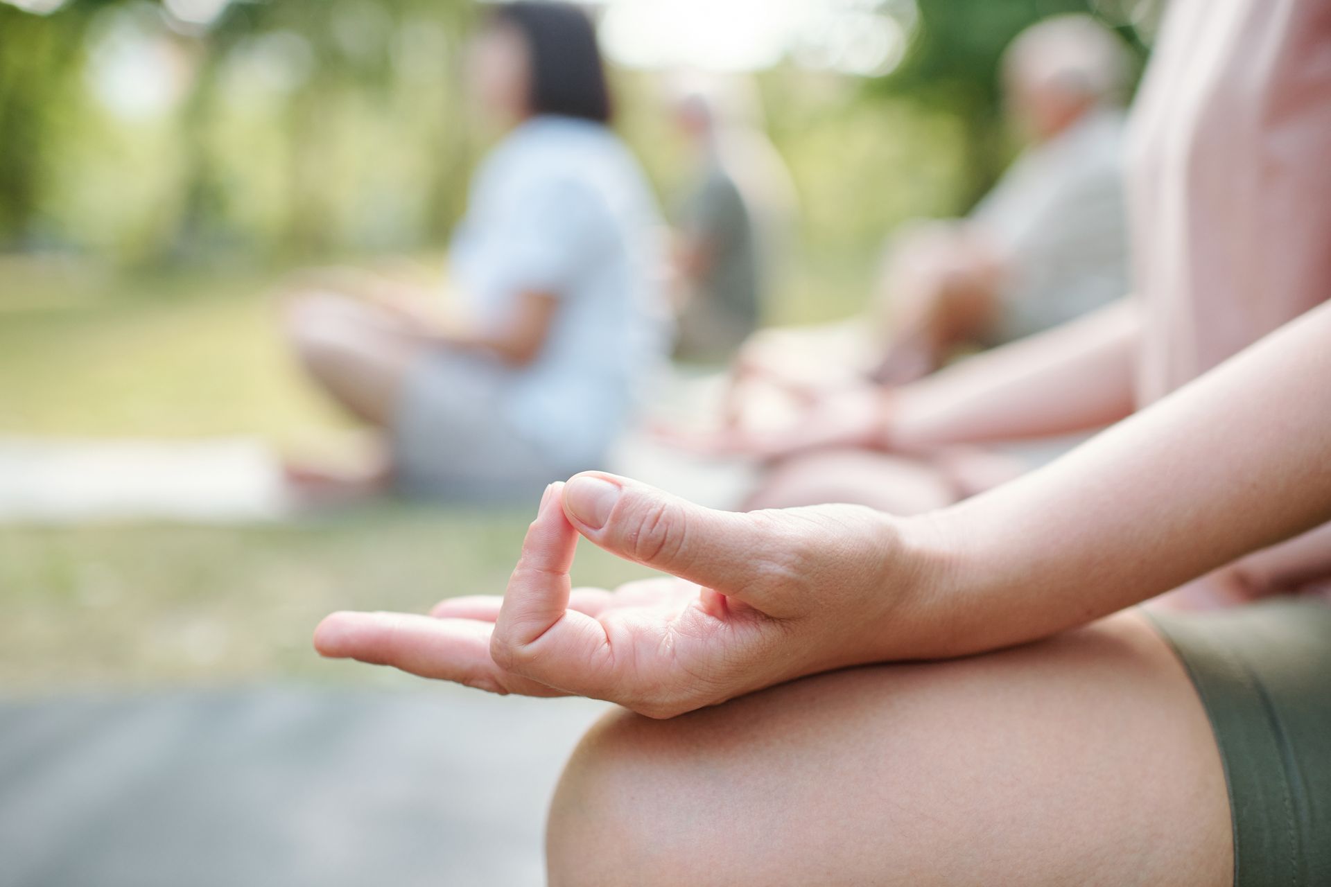 closeup of person meditating in park