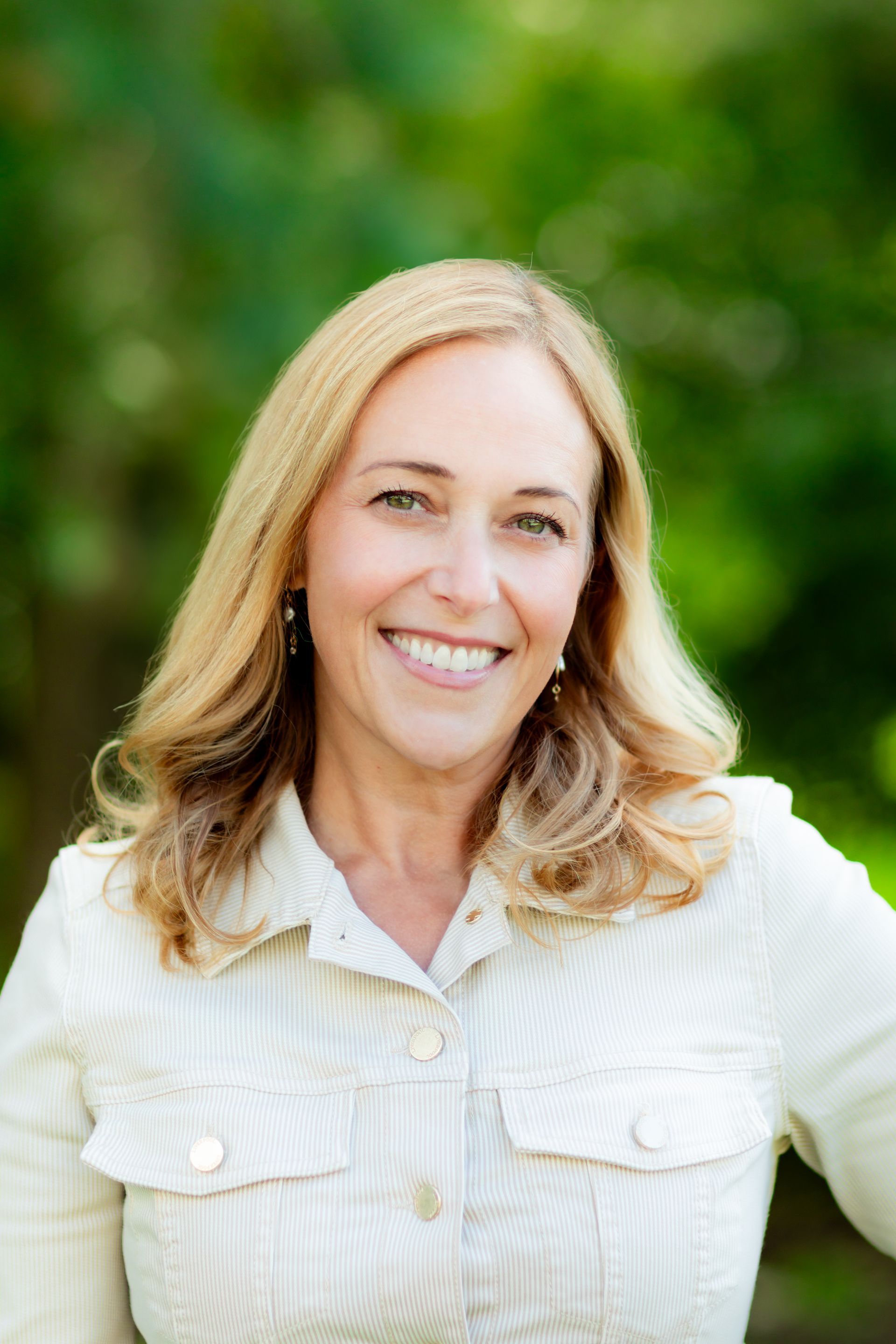 A woman in a black shirt is smiling for the camera.