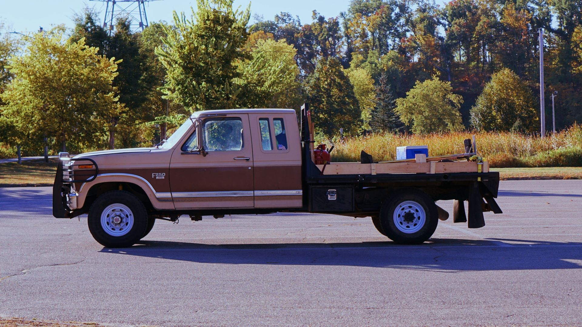 a brown ford truck is parked in a parking lot