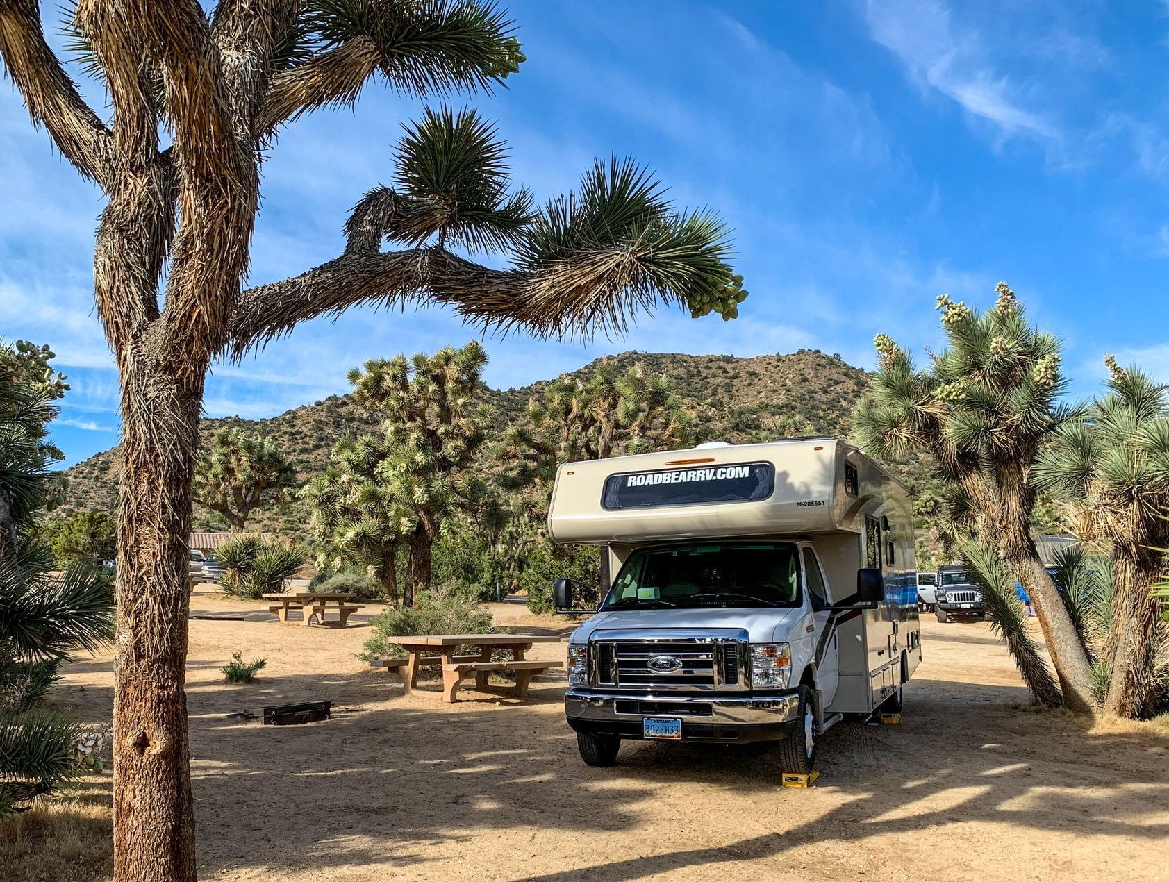 a road bear rv is parked in the desert