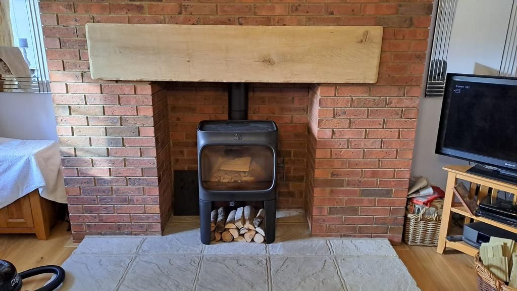 Jotul F167 wood burner on pedestal with twin wall flue system up through the roof installed by the Fireplace Isle of Wight 