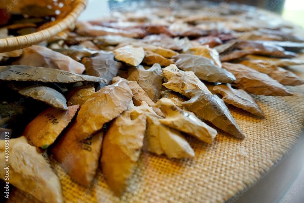 A pile of rocks on a table with a basket in the background.
