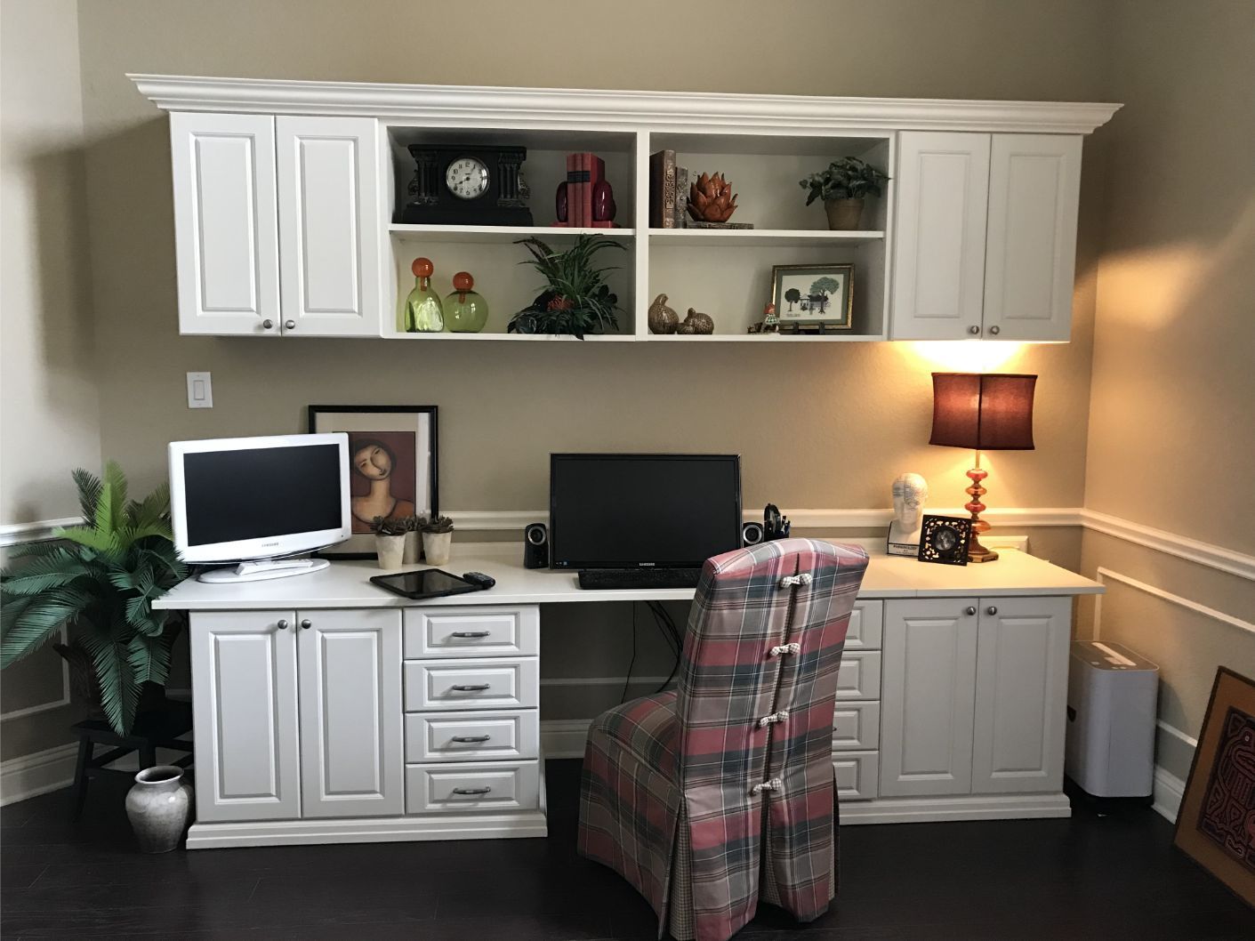 a desk with a computer and a chair in a home office