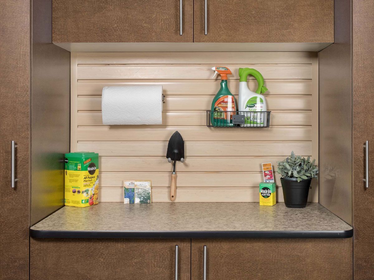 a workbench with a spray bottle and a shovel on it .
