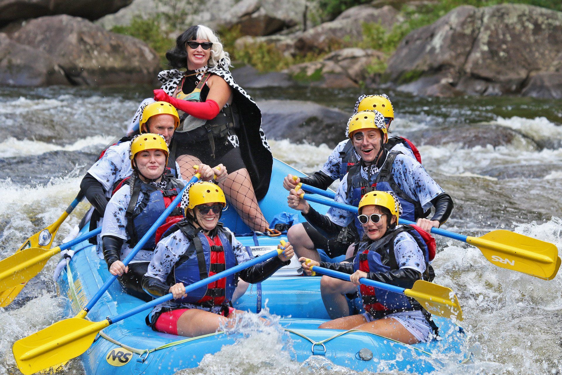 Group of people rafting with costumed woman