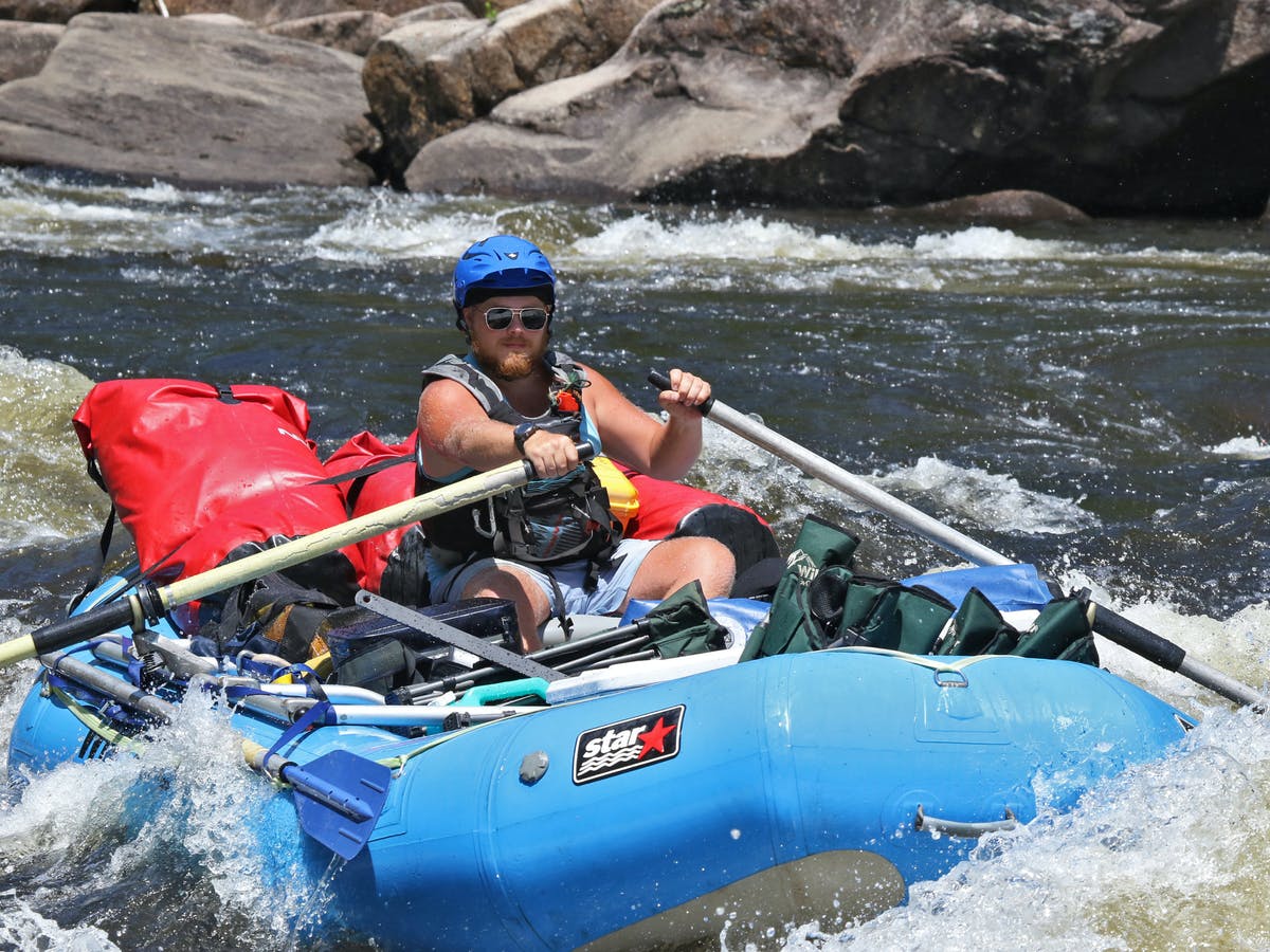 One man paddling in whitewater
