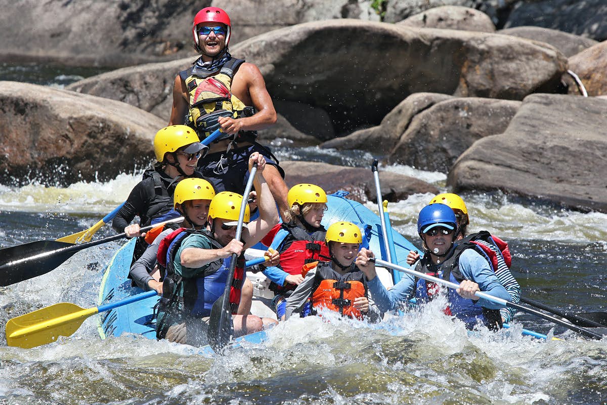 Group of people and children are rafting