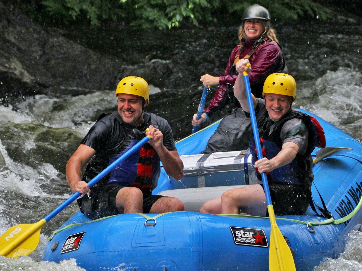 Three people enjoying rafting