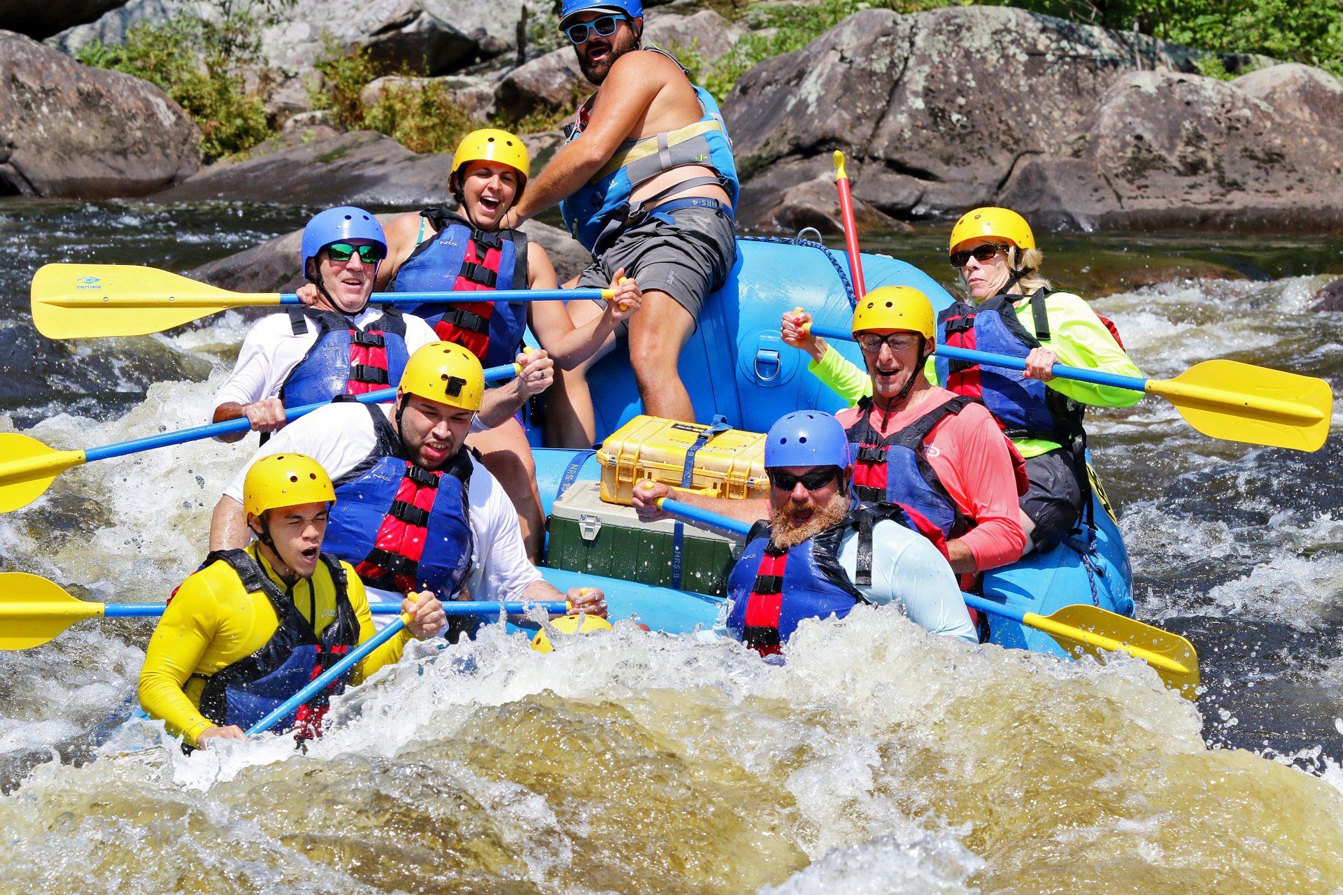 Group of people paddling through whitewater