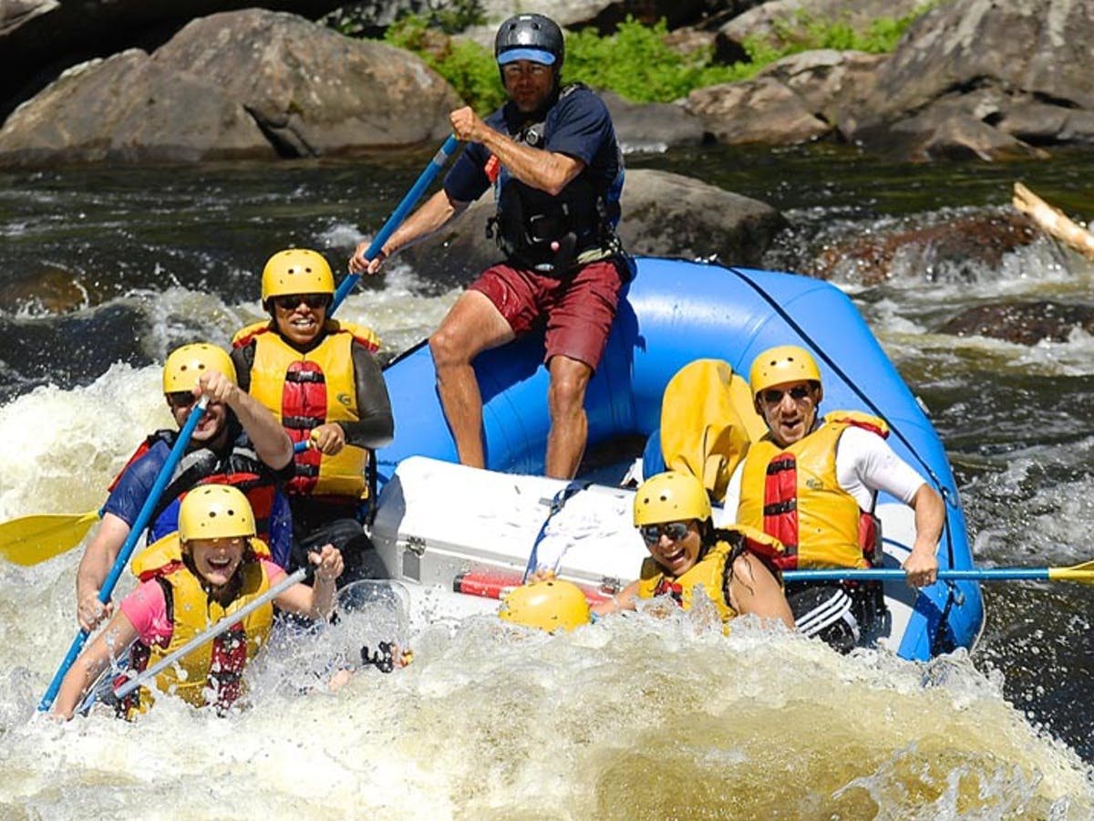 People enjoying paddling while on yellow life vest and helmet