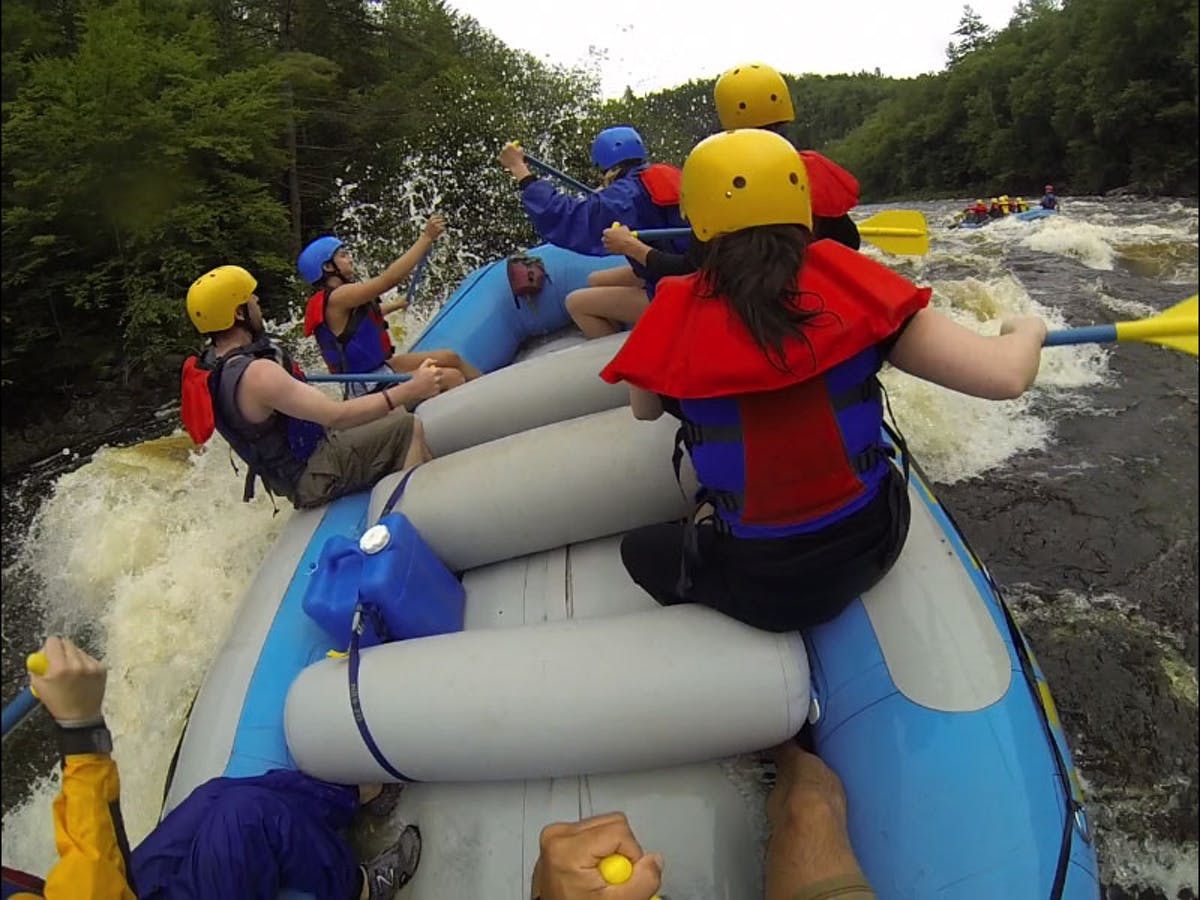 Back view of group of people while rafting