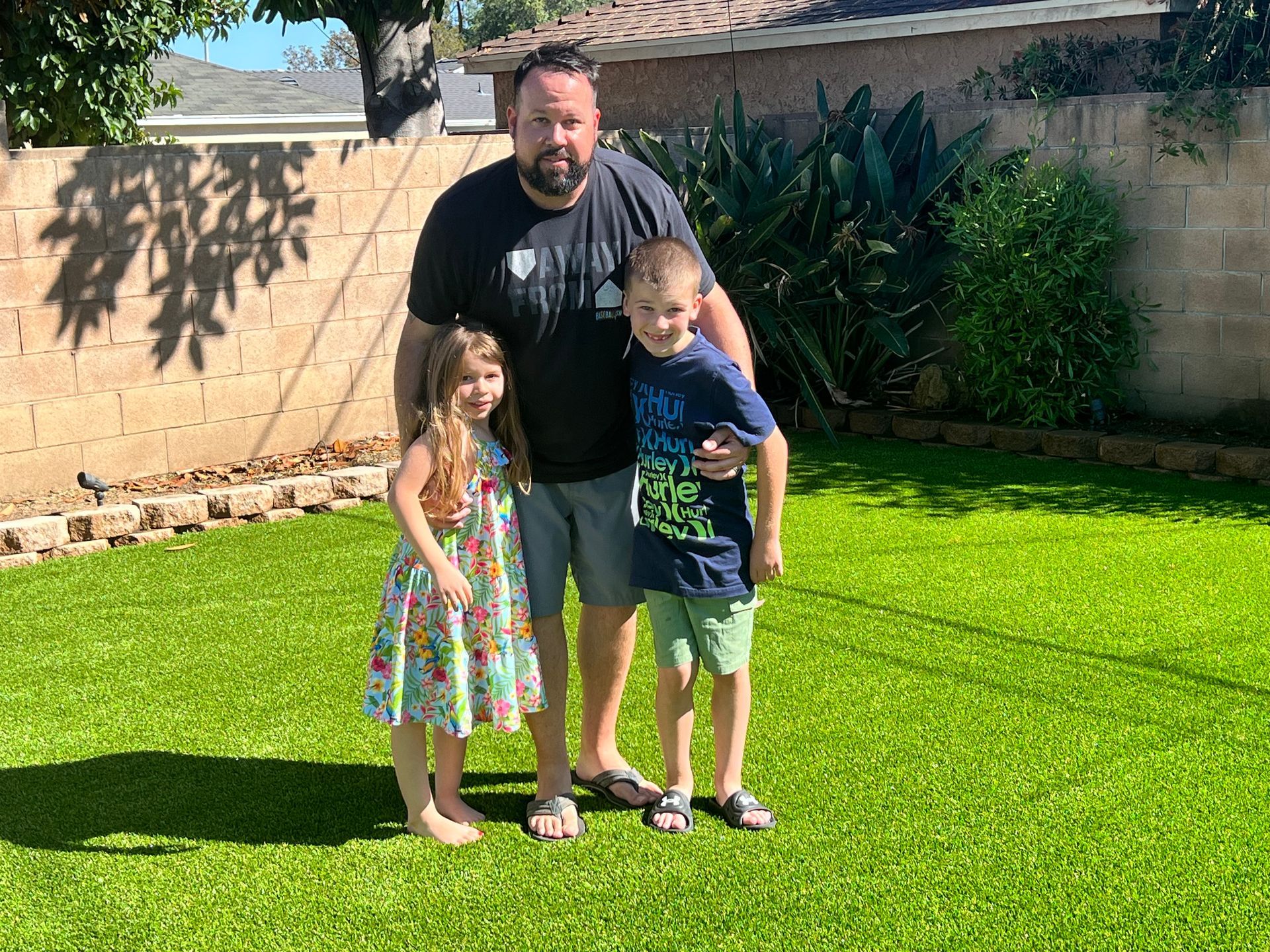 family on fake grass Buena Park