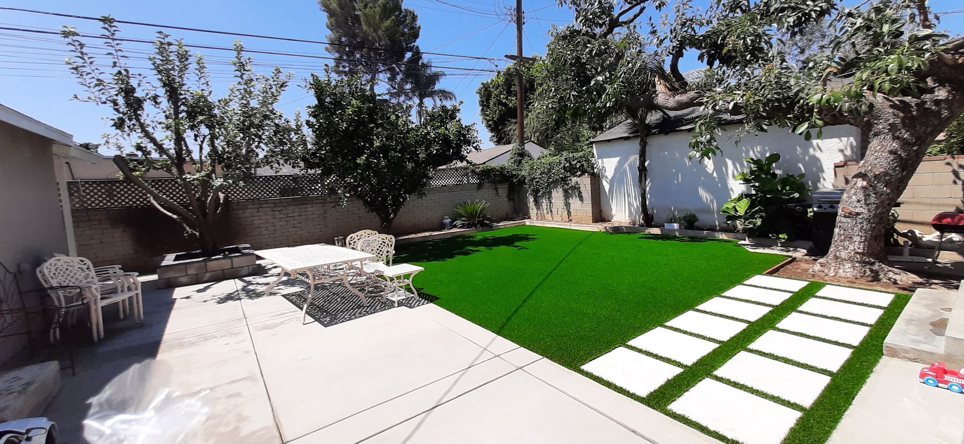 beautiful, redesigned artificial grass back yard