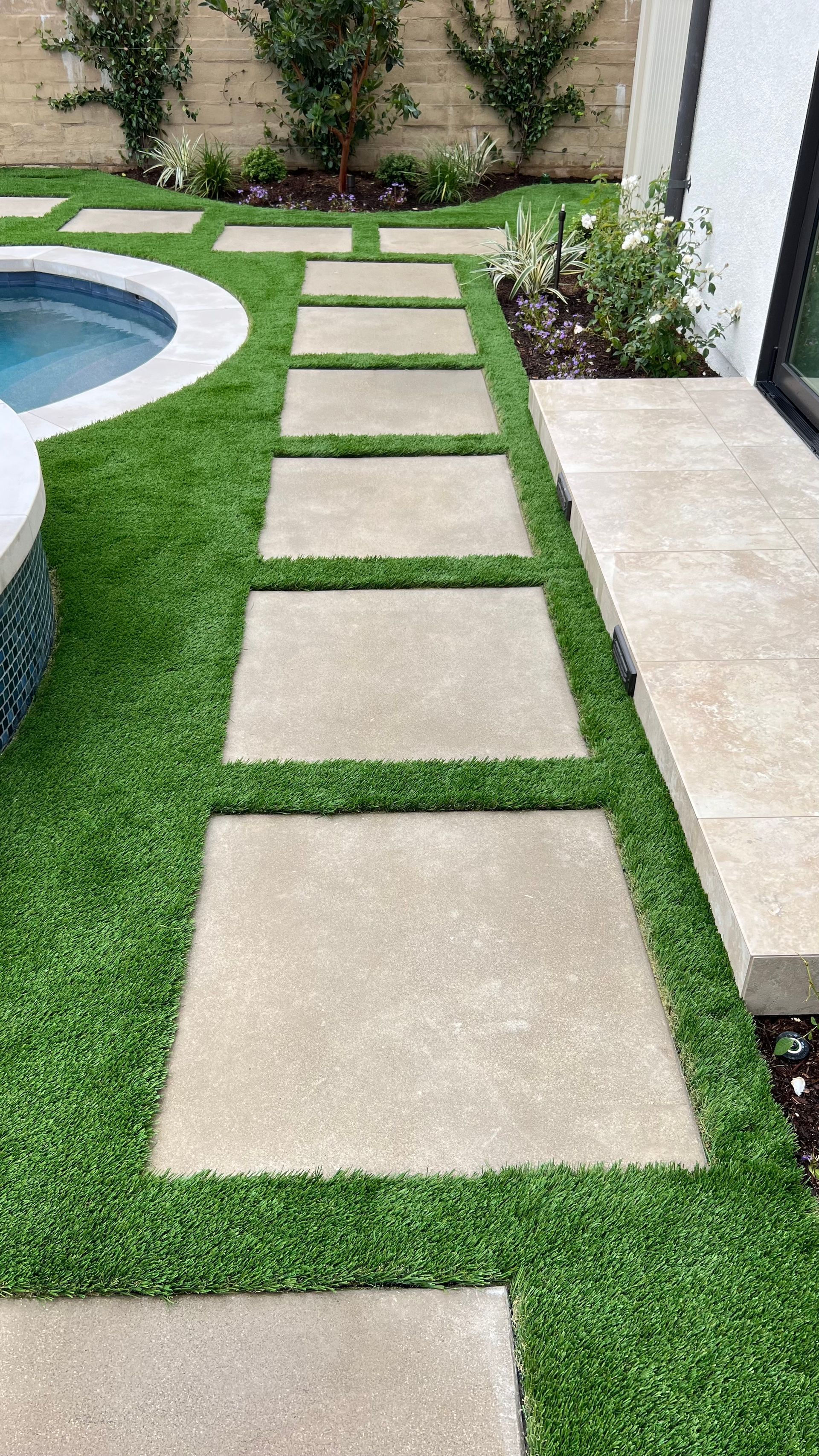 artificial grass next to pool
