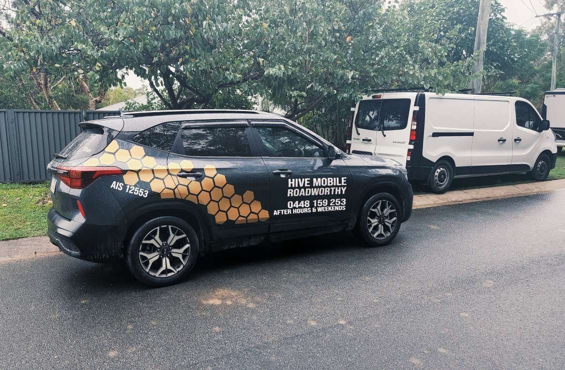 A Black Car With a Honeycomb Design is Parked Next to a White Van — Hive Mobile Roadworthy in Currumbin, QLD