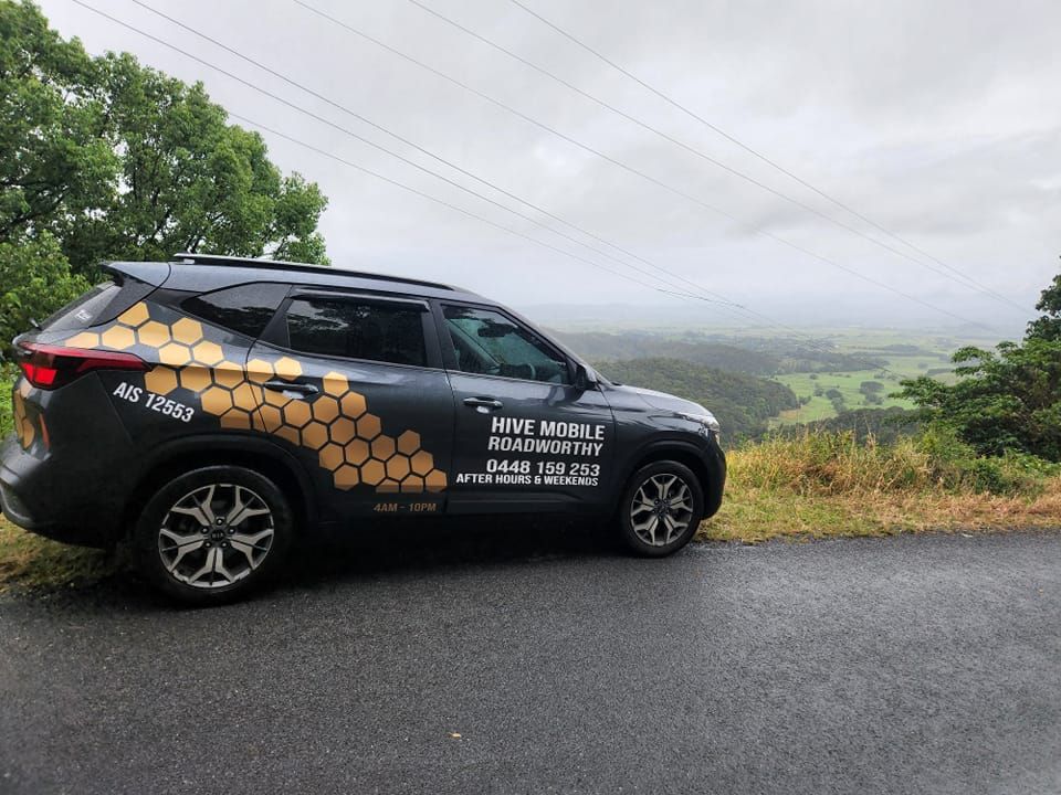 A Black SUV is Parked on the Side of a Road — Hive Mobile Roadworthy in Pimpama, QLD