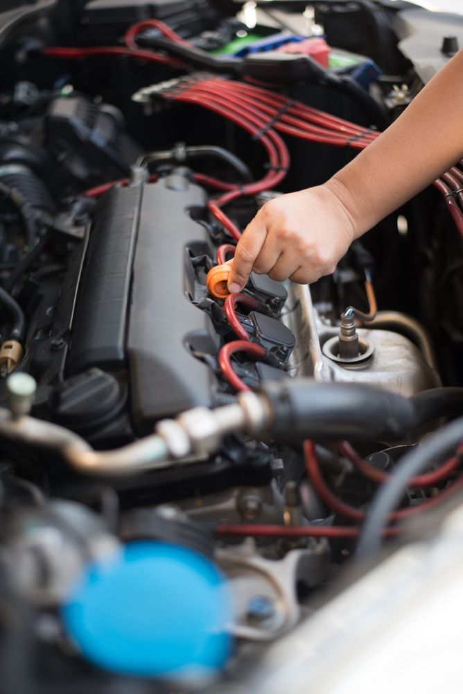 A Person is Working on a Car Engine With a Wrench — Hive Mobile Roadworthy in Southport, QLD