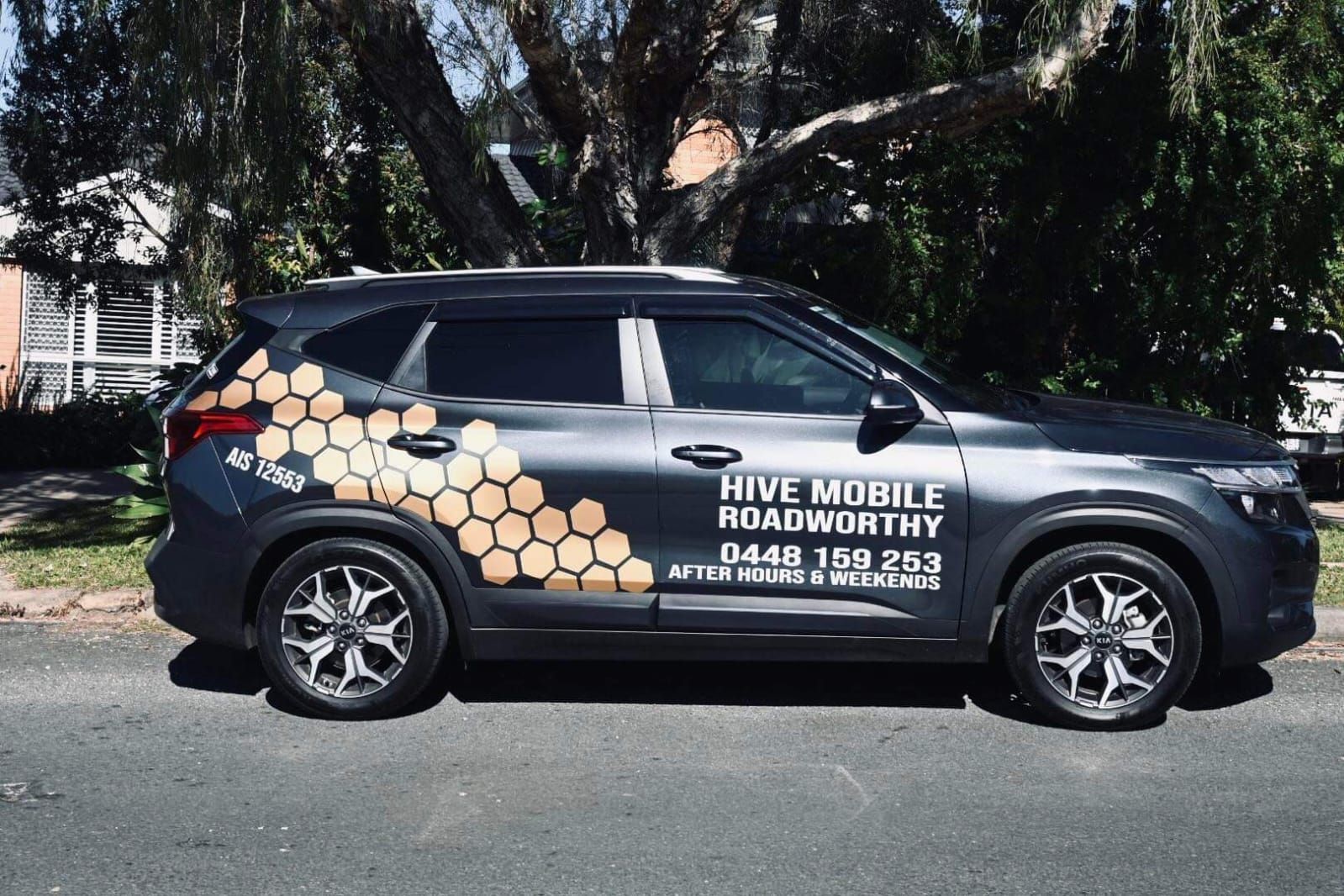 A Hive Mobile Roadworthy Car is Parked on the Side of the Road — Hive Mobile Roadworthy in Highland Park, QLD