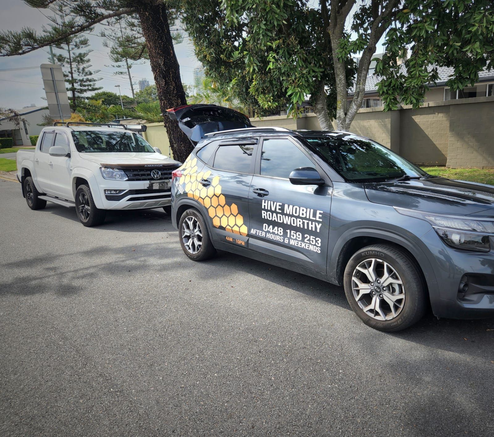 Two Cars Are Parked Next to Each Other on the Side of the Road — Hive Mobile Roadworthy in Highland Park, QLD