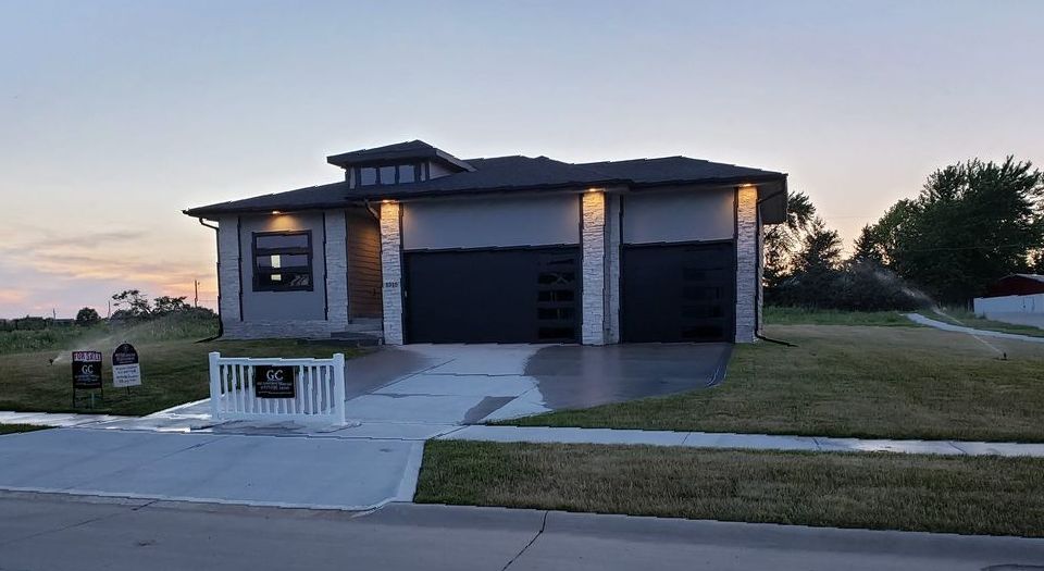 A large house with two garages is for sale in a residential area.