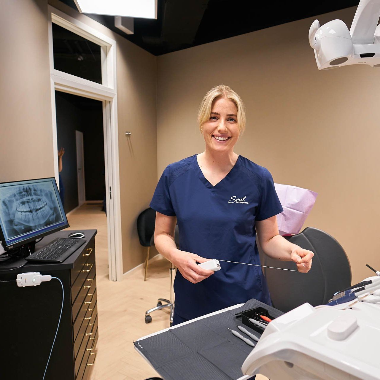 Tannlege Trine viser frem tenner til en pasient hos Smil Tannlegesenter i Oslo