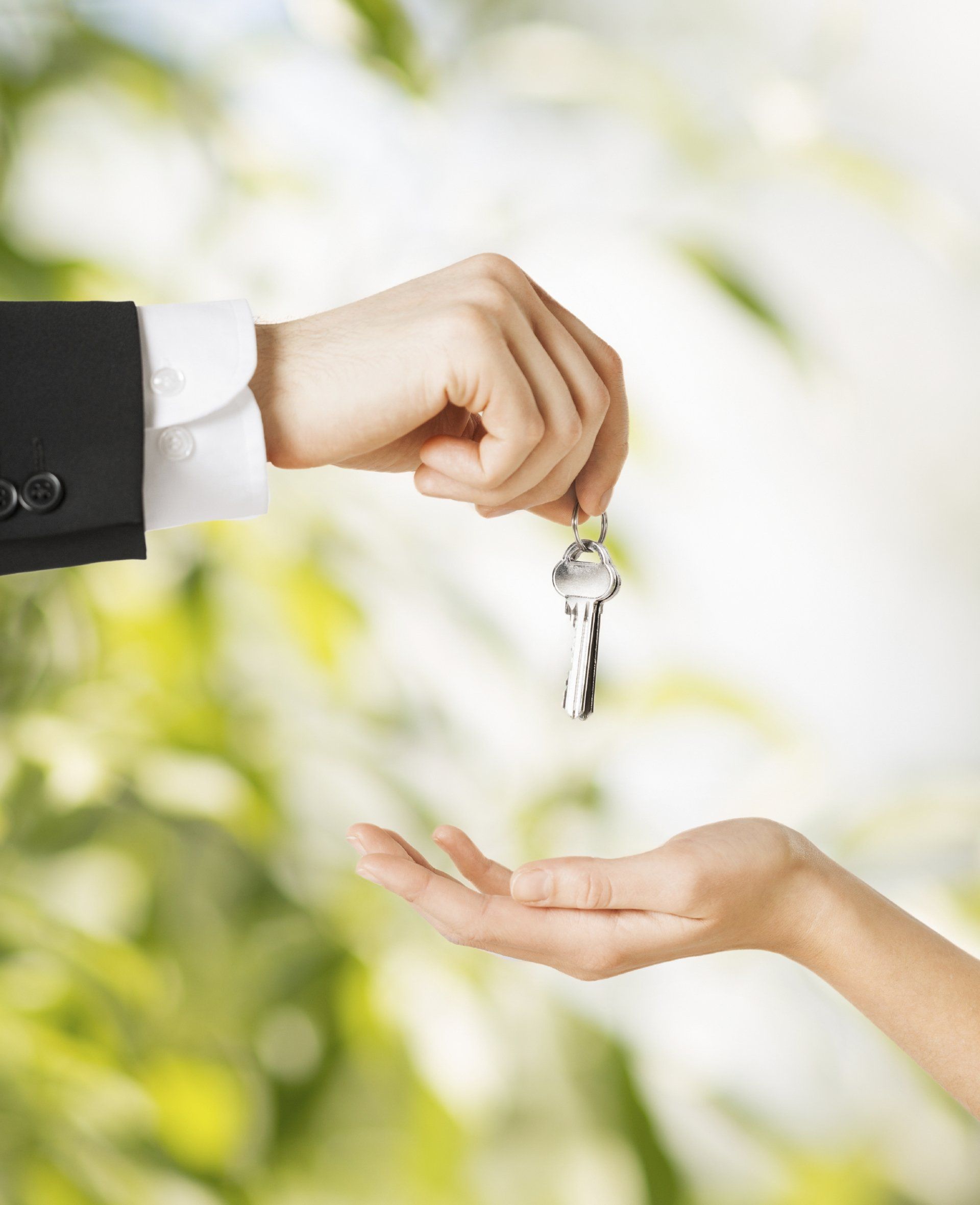 picture of man hand passing house keys to woman