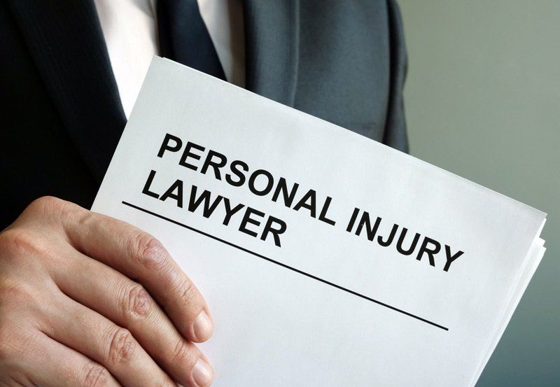 Attorney Holding Personal Injury Document | Fairmont, WV | Higinbotham & Higinbotham, PLLC