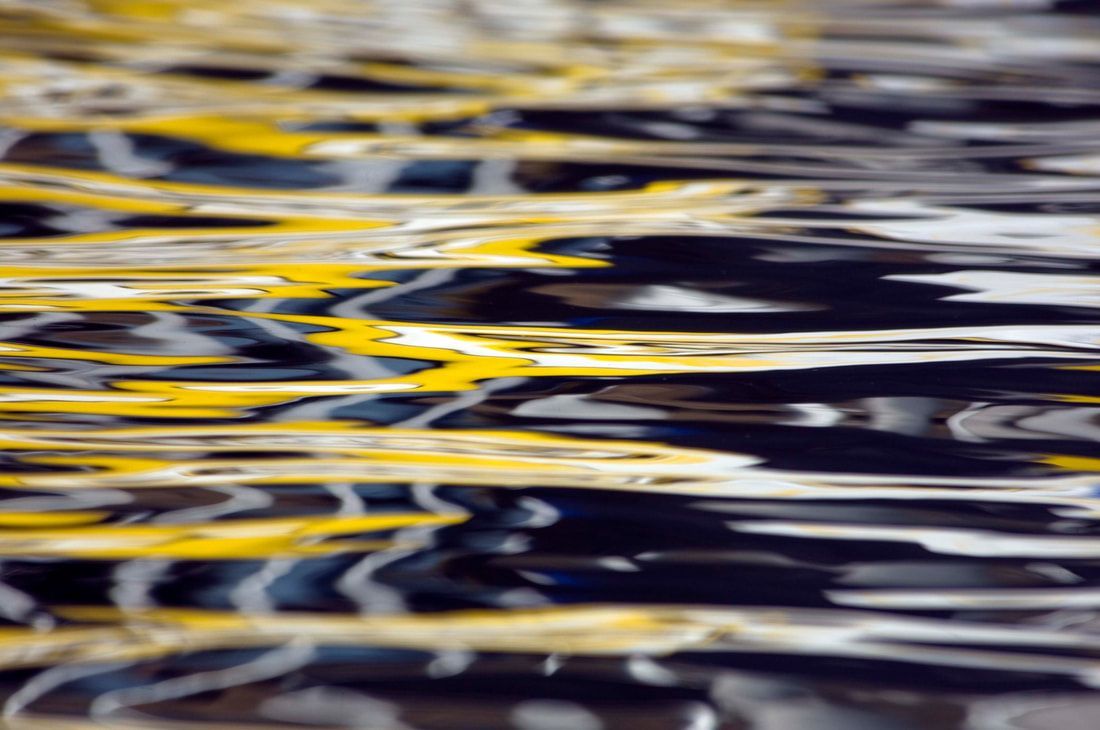 A close up of a body of water with yellow and black waves