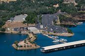 An aerial view of a marina with boats docked and a small island in the middle of the water.