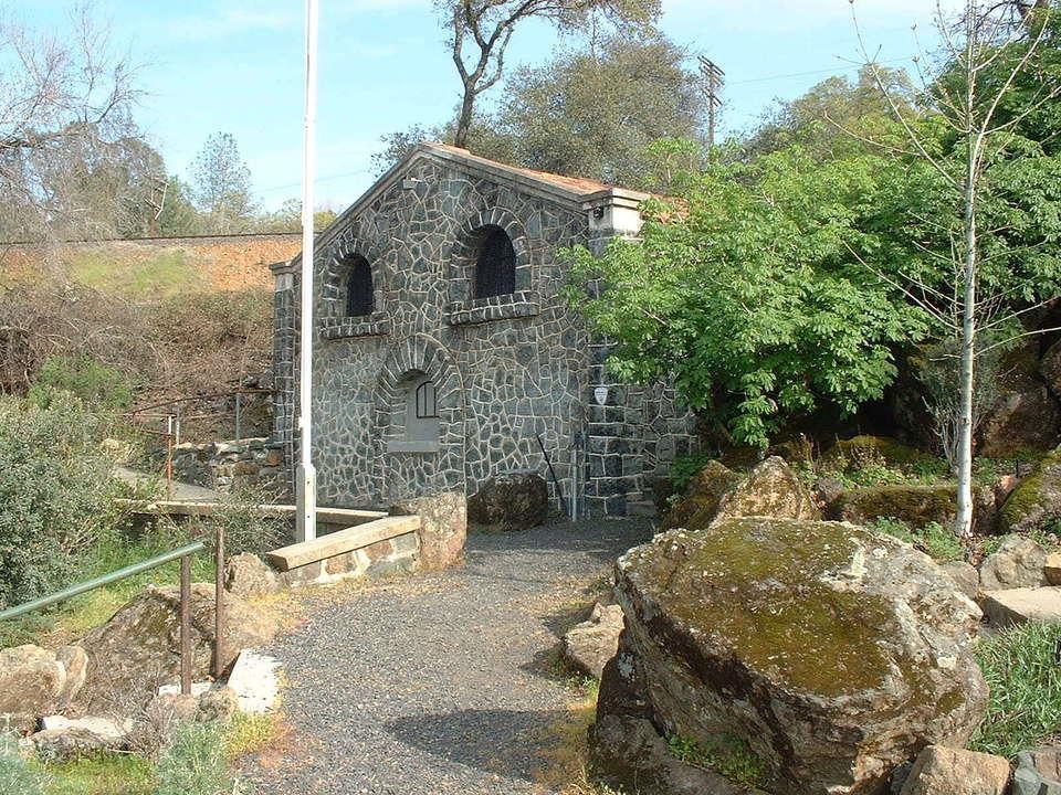 A stone building with a flag in front of it