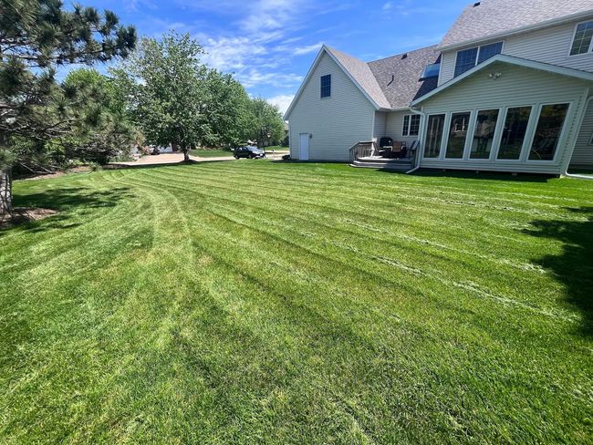 Professional lawn mowing service in the Quad Cities area, covering Moline, Davenport, Bettendorf, and Rock Island