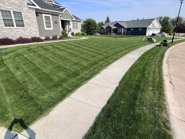 Professional lawn mowing service in the Quad Cities area, covering Moline, Davenport, Bettendorf, and Rock Island