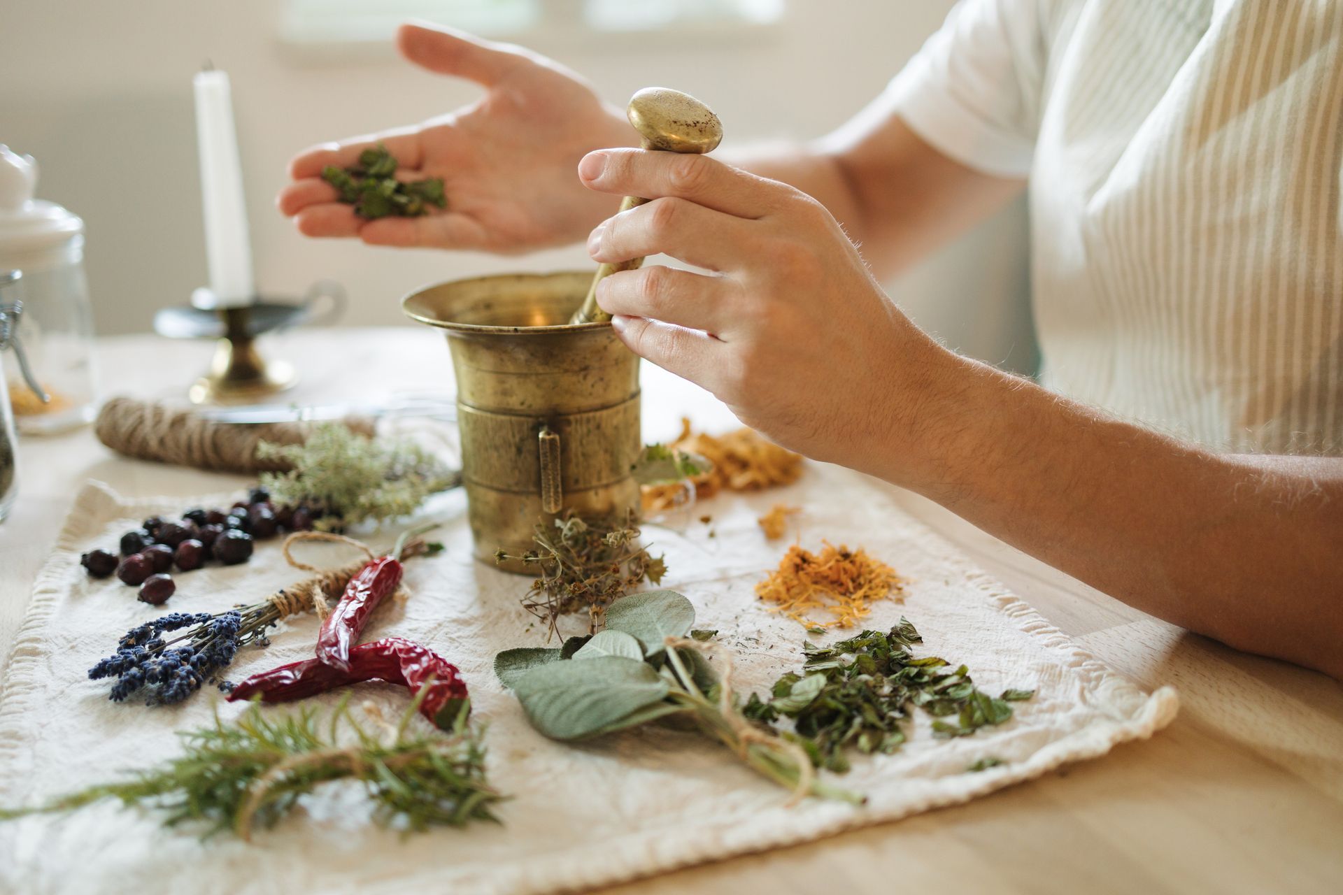 a woman preparing herbs for naturopathic medicine