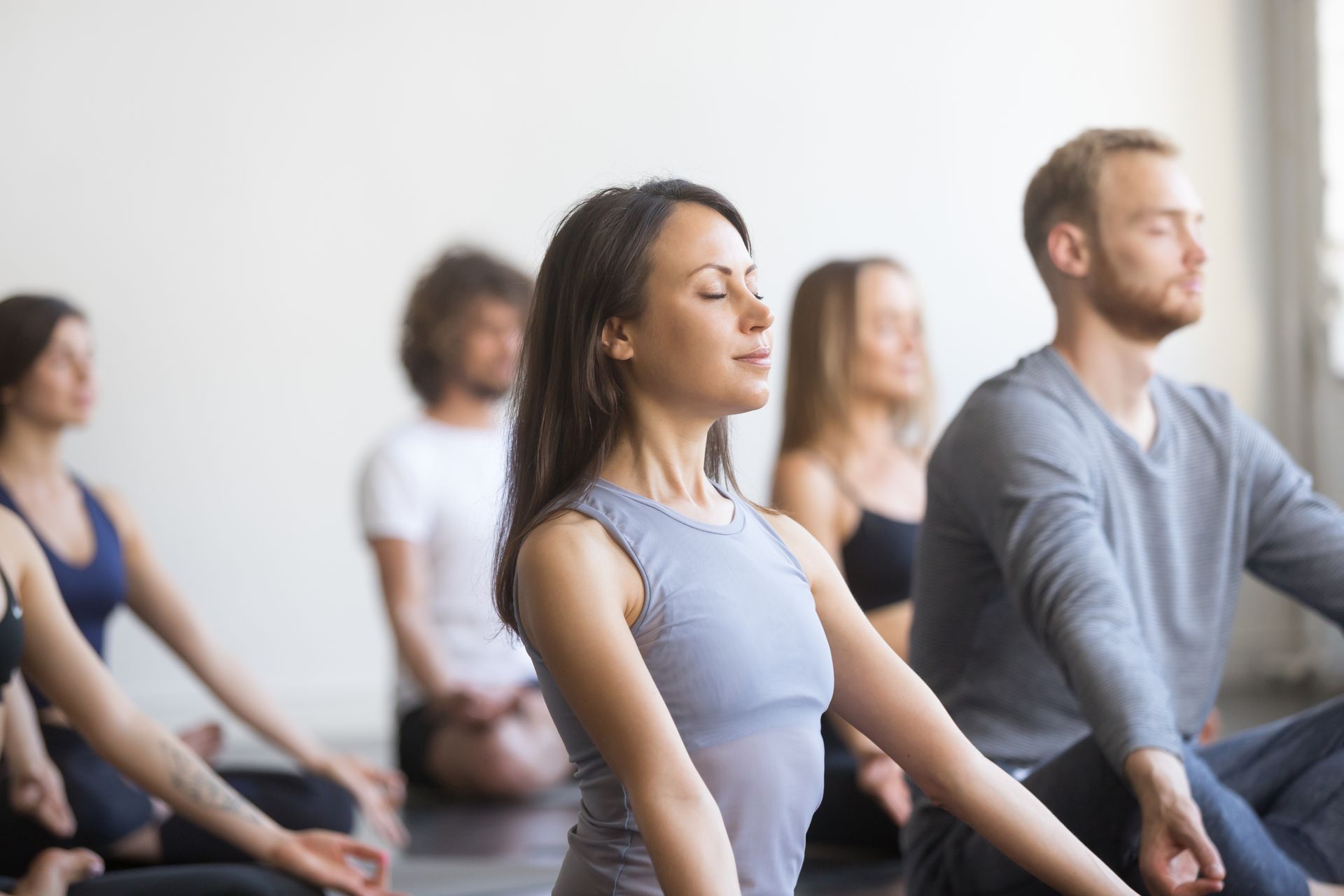 a group of people meditating in a room