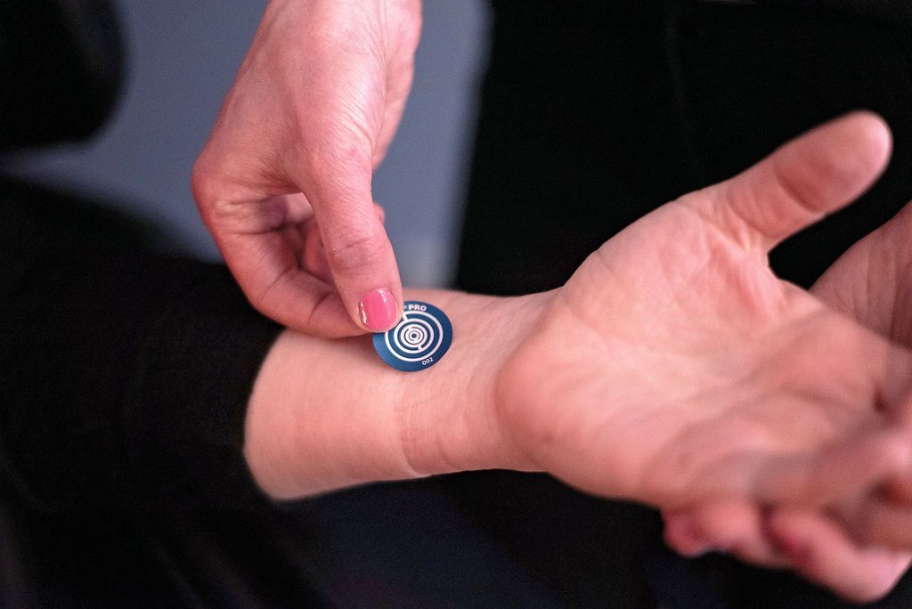 putting NuCalm's Biosignal processing disc on a man's wrist