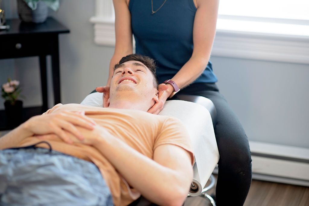a man laying on a table getting a massage from a woman